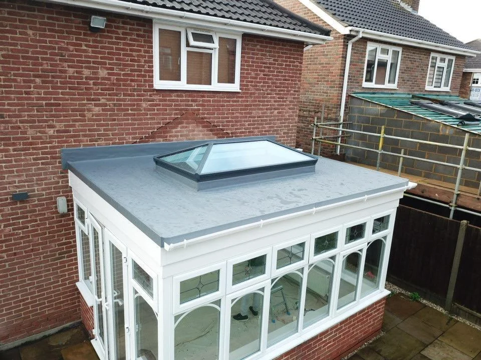 New grey membrane flat roof with a roof lantern on a conservatory