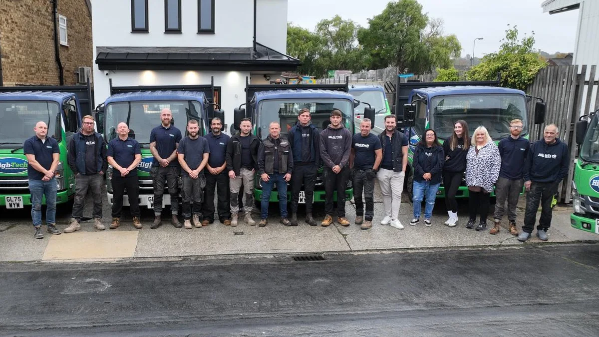 The High-Tech Membrane Roofing team with their branded trucks
